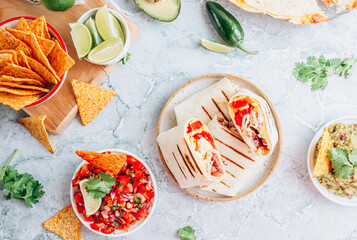 Burritos wraps with mincemeat, beans and vegetables. Mexican dish