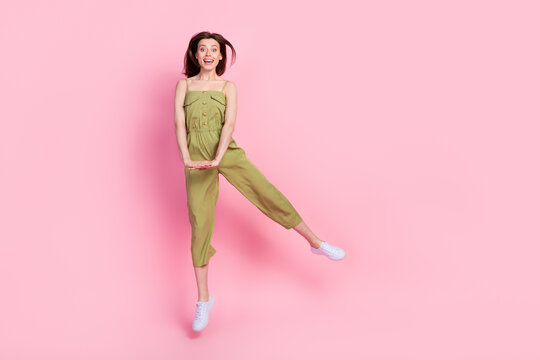 Full length photo of satisfied pretty lady dressed khaki outfit dance rejoice shopping sale empty space isolated on pink color background