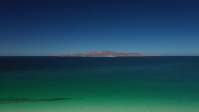 Aerial view of azure turquoise sea and deep blue sky. Playa El Tecolote. Nature of Mexico