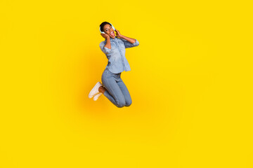 Fototapeta na wymiar Full body overjoyed funky person hands touch headphones enjoy mo3 melody isolated on yellow color background