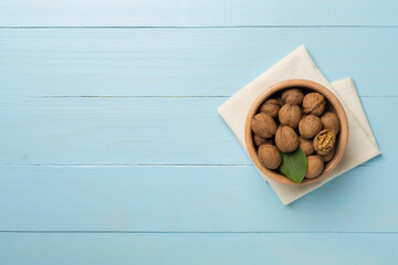 Fresh walnuts on wooden background, top view