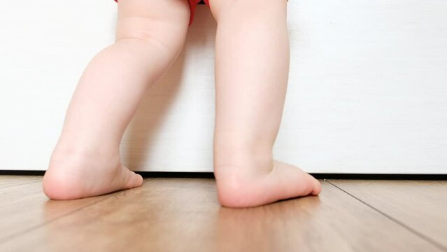 The legs of a child who is learning to walk