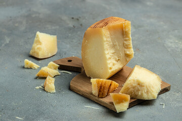 gruyere hard yellow cheese. a traditional Swiss hard yellow cheese without holes, with a dark crust and a pleasant floral and nutty aroma, place for text, top view