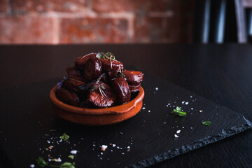A Tapas bowl filled with Chorizo at a Tapas Bar