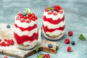 Cranachan raspberry dessert in jar on a light background. Long banner format