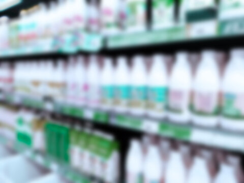 Abstract blur image of supermarket background. Defocused shelves with dairy products. Grocery. Retail industry. Rack. Discount. Inflation and crisis concept. Aisle. Consumer packaged goods. CPG. Store