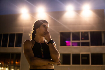 woman running on a running track at night