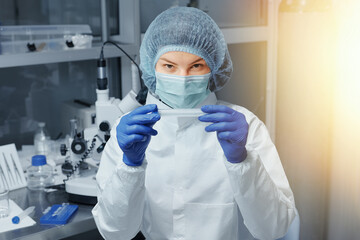 Medical worker or Scientist in a medical research laboratory holds a test tube. Biochemical analysis