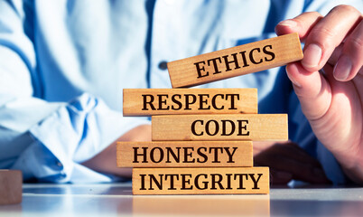 Wooden blocks with words 'ethics, respect, code, honesty, integrity'. code of conduct