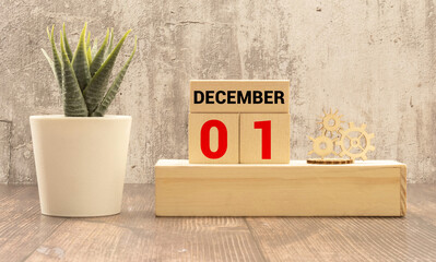 December 1st. Image of december 1 wooden color calendar on white brick wall background.