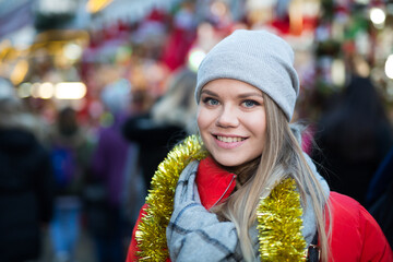 Portrait of smiling woman shopping on festive fair before Christmas