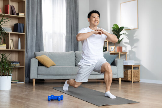 Athletic asian man training alone at home