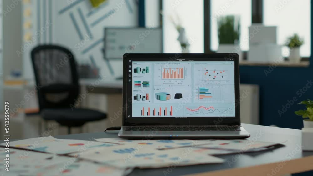 Poster closeup of laptop screen with enterprise resource planning showing moving charts and growing turnove