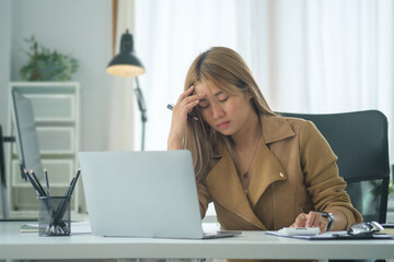 Tired businesswoman suffering from headache , stress at work or migraine concept.