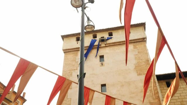 Mediaval building with mediavel style flags. Cocentaina mediaval fair Tots Sansts, Alicante Spain.
