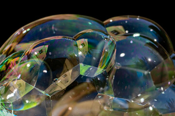 Colorful soap bubbles with mirroring of house