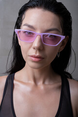 Young woman wearing modern pink sunglasses. Fashion and style. Summer vibes