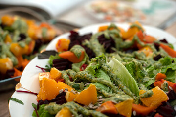 Cooking grilled salad of beetroot, pumpkin, orange, cream cheese.