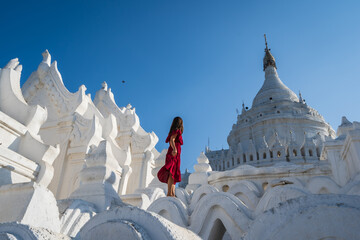 Young woman traveler at Hsinbyume Pagoda (white pagoda) the famous destination in Myanmar