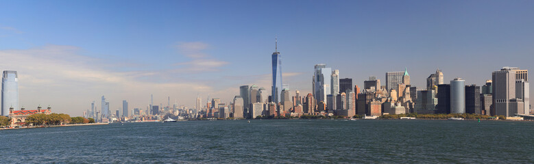 Panoramic view of New York City skyscrapers of (Lower Manhattan) and Ellis Island viewed from the...