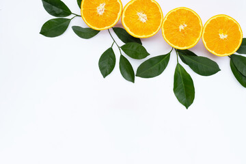 Orange fruit with green leaves on white background.