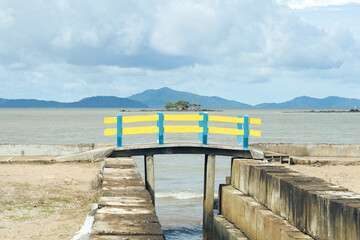yellow and blue bridge by the beach