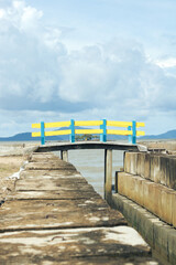 yellow and blue bridge by the beach