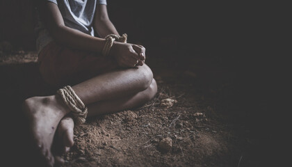 hopeless boy  hands tied together with rope, human trafficking