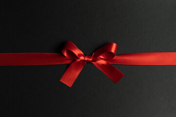 Red ribbon bow on black