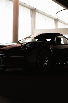 Vertical Shot Of A Porsche 911 Turbo Silhouette In A Showroom