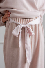 Pastel home wear pants with big pink bow on slim woman