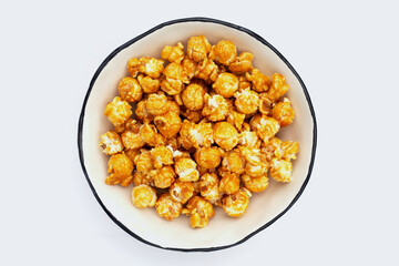 Honey caramel popcorn on white background.