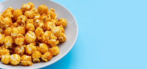 Honey caramel popcorn on white background.
