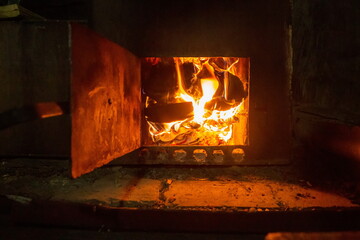 burning firewood in the stove in the Russian bath