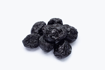 Dried prunes on white background