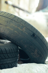 piles of used car tires that have been used and worn to be recycled
