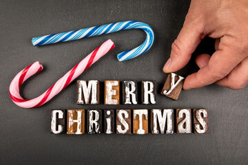 Merry Christmas. Text from wooden alphabet letters on a dark background