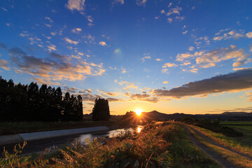山に沈む秋の夕日　川に反射　空のグラデーション　10月