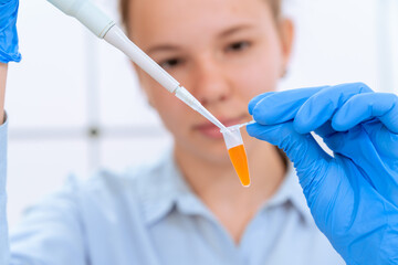 young woman in a microbiological laboratory fill microbes for PCR analysis genetic study