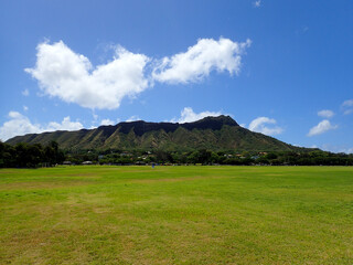 Kapiolani Park at during day with Diamond Head and clouds