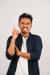 Portrait of Happy young asian man in blue shirt have idea isolated on white background