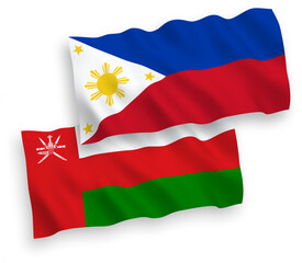 National vector fabric wave flags of Sultanate of Oman and Philippines isolated on white background. 1 to 2 proportion.