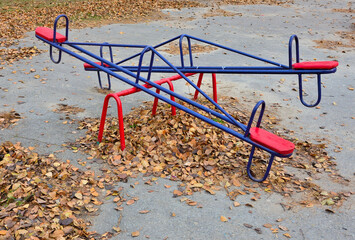 Swing on an empty playground on an autumn day