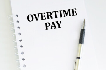Financial concept about OVERTIME PAY with sign on the sheet.