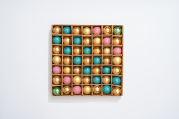 cardboard box with many christmas balls, with a white background