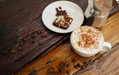 Hot cappuccino in white cup with wooden background,coffee is a popular drink all over the world.