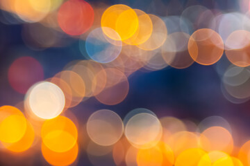 Abstract city lights blur blinking background. Soft focus horizontal long banner. Bokeh sparkles colorful defocused on dark texture for night party city. Abstract blurred pattern template.