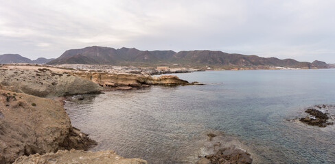 Aerial view of sea waves breaking rocky beach in Almeria