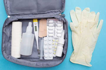 First aid kit with a set of medicines and tablets for first aid and illness. Necessary and...