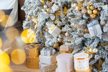 Christmas presents under the Christmas tree. New Year's and Christmas. Wrapped Gift. Beautiful packaging. Ribbon and bow on the packaging.